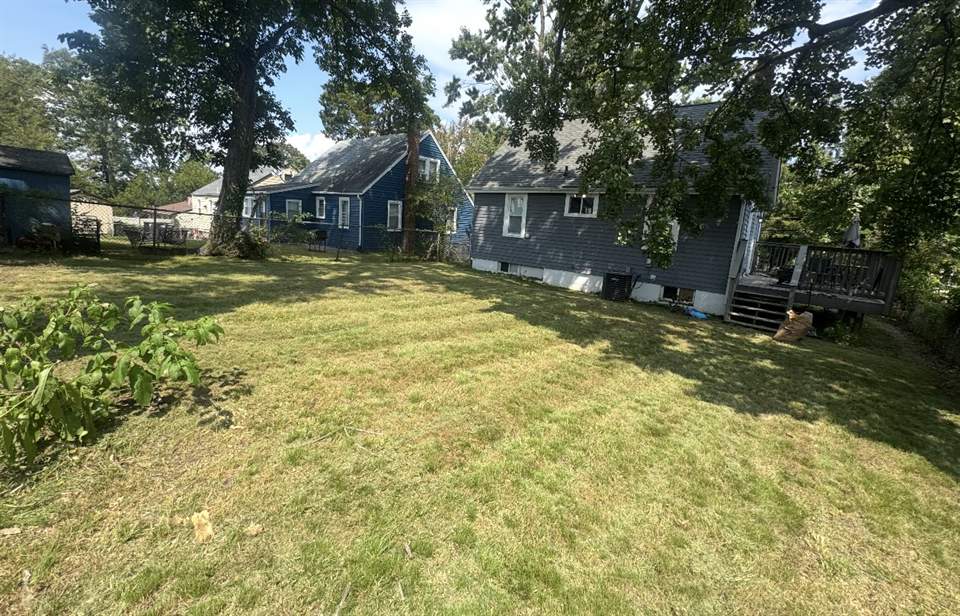 Wide back yard cut clean between two houses