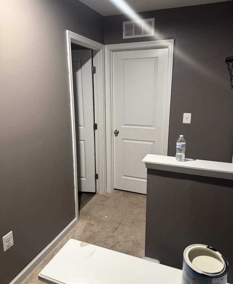 Freshly painted room with grey walls and crisp white trim and doors